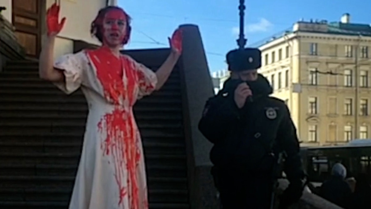 Russian Artist Doused In Fake Blood Protests Against War