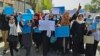 Afghan women and girls take part in a protest in Kabul on March 26, demanding that high schools be reopened for female students. 