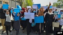 Afghan women and girls take part in a protest in Kabul on March 26, demanding that high schools be reopened for female students. 