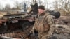 Украинский военнослужащий возле уничтоженного российского танка Т-72 в освобожденном селе Лукьяновка Киевской области, 27 марта 2022 года