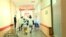 Medical workers running through the hospital corridor
