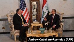 U.S. Secretary of State Mike Pompeo (left) is hosting diplomats from dozens of countries involved in the effort to defeat Islamic State militants. He is shown here with Iraqi Foreign Minister Mohammed Ali al-Hakim during talks last month in Baghdad.