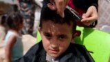 Syria, Syrian women offer free haircuts for children in displacement camps ahead of Eid, video grab