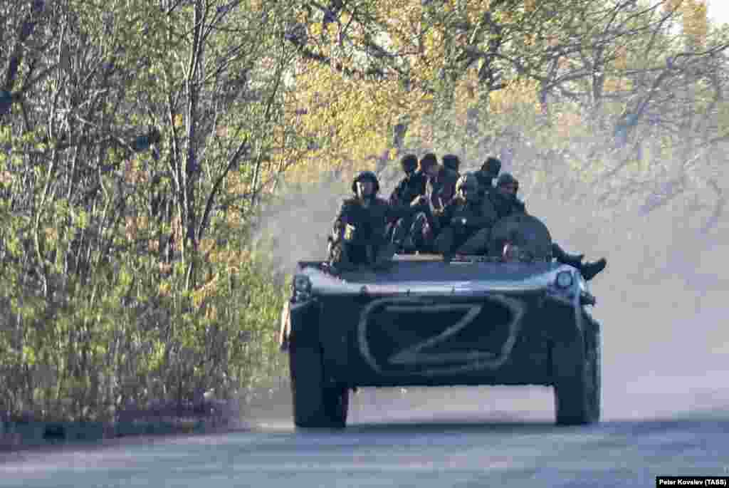 Kremlin-backed separatist fighters ride an armored vehicle in the Donetsk region on April 27.&nbsp;