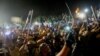 Supporters of the Jamiat Ulema-e-Islam party wave sticks at an anti-government rally organized by the Pakistan Democratic Movement (PDM), an alliance of political opposition parties, on March 28. 