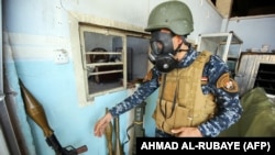 An Iraqi soldier wears a gas mask on April 16 in Mosul.