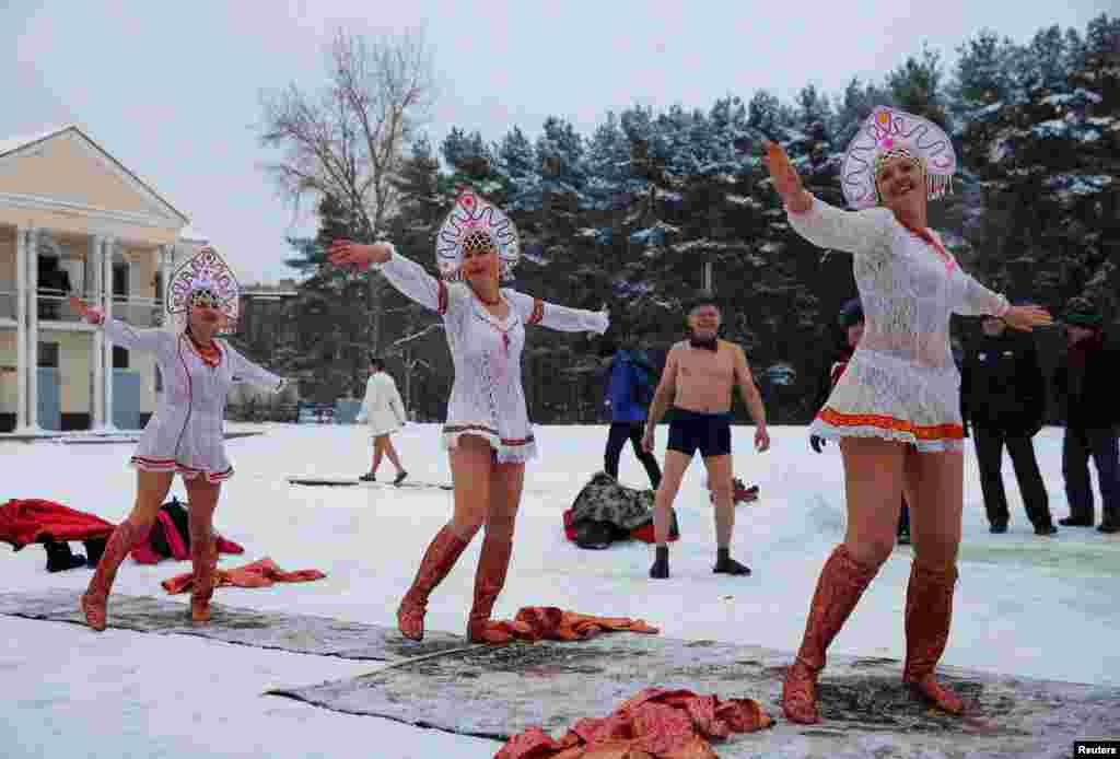 Participants wearing traditional Russian head wear perform during a winter swimming festival in the town of Podolsk, south of Moscow. (Reuters/Maxim Shemetov)