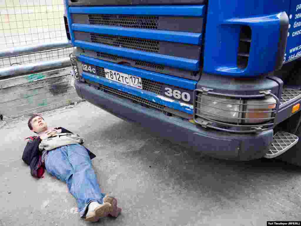 А protester blocks a truck at the gate to a construction site in Moscow's historic Kadashi district, which activists say is threatened by redevelopment plans. Photo by RFE/RL