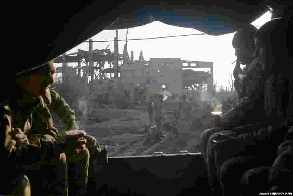 Ukrainian servicemen sit in a truck to head to a polling station, near the front line with Russia-backed separatists, near Butivka, in eastern Ukraine. (AFP / Anatolii Stepanov)