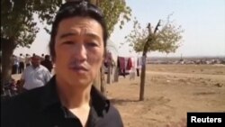 Japanese journalist Kenji Goto reports from the embattled Syrian town of Kobani in October 2014.