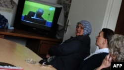 Muslim women in Sarajevo, survivors of the 1995 Srebrenica massacre, watch a live television broadcast in May of the first day of Ratko Mladic's trial in The Hague.