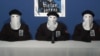 Spain -- ETA militants dressed in black shirts with white hoods over the heads and black berets making a declaration in an undisclosed location, 20Oct2011