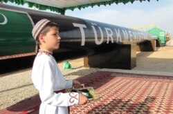 A Turkmen boy in traditional dress takes part in a gas pipeline ceremony. (file photo)