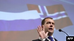 Russian President Dmitry Medvedev speaks at a business seminar. The Russian flag -- rather than the Freedom Forum banner -- is taking center stage in Oslo.