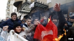 Russians burn a Turkish flag during a rally in front of Turkish Embassy in Moscow on November 25.