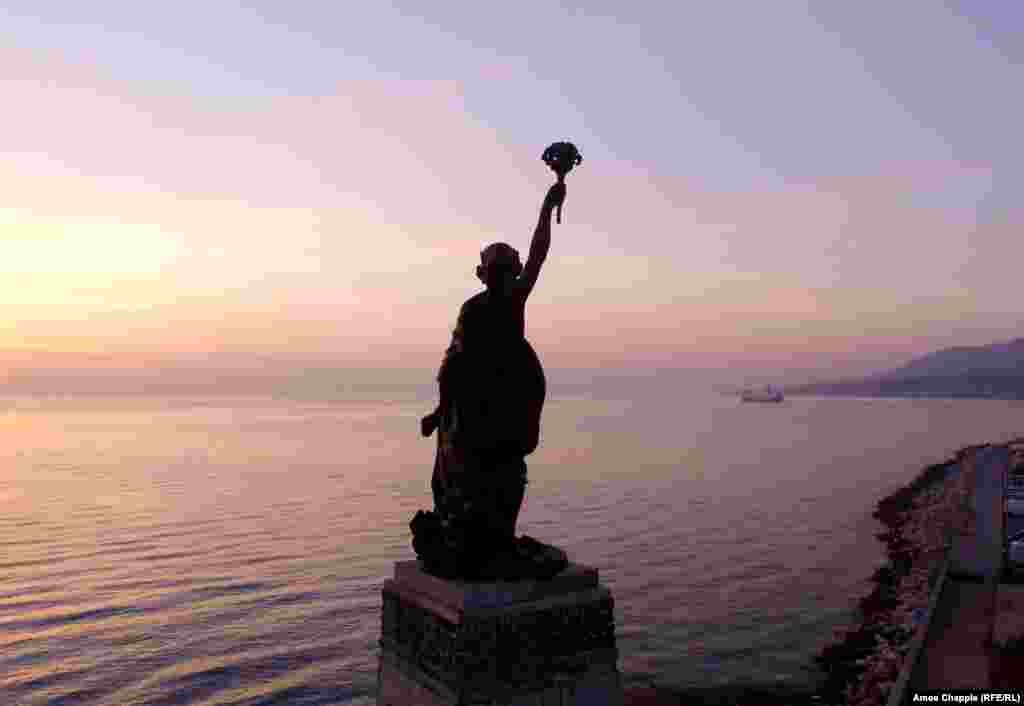 Lesbos's Statue of Liberty looks toward the Greek mainland as a ferry containing migrants steams toward Athens.