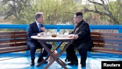 The two Korean leaders meet during their previous summit in April.