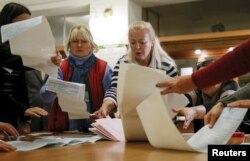 Members of a local electoral commission count ballots in Kyiv.