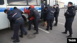 Russian Police detain alleged illegal migrants during a raid at a market in Moscow last month.