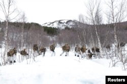 U.S. Marines participate in a military exercise called Cold Response 2022, gathering around 30,000 troops from NATO member countries, plus Finland and Sweden, amid Russia's invasion of Ukraine, near Bjerkvik in the Arctic Circle in Norway on March 24.
