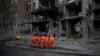 Clean-up crews prepare to work at the site of an explosion in Kyiv on April 29.