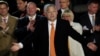 Hungarian Prime Minister Viktor Orban reacts in front of supporters after the announcement of preliminary parliamentary election results in Budapest on April 3.