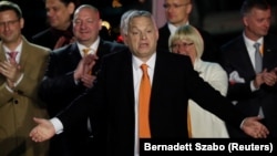 Hungarian Prime Minister Viktor Orban reacts in front of supporters after the announcement of preliminary parliamentary election results in Budapest on April 3.