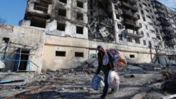 Local resident and shoemaker Gennady, who didn't give his full name, transports belongings from his house destroyed in the course of Ukraine-Russia conflict in the besieged southern port city of Mariupol, Ukraine March 28, 2022. 