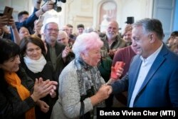 Prime Minister Viktor Orban greets supporters of his Fidesz party on the eve of April 3 elections.