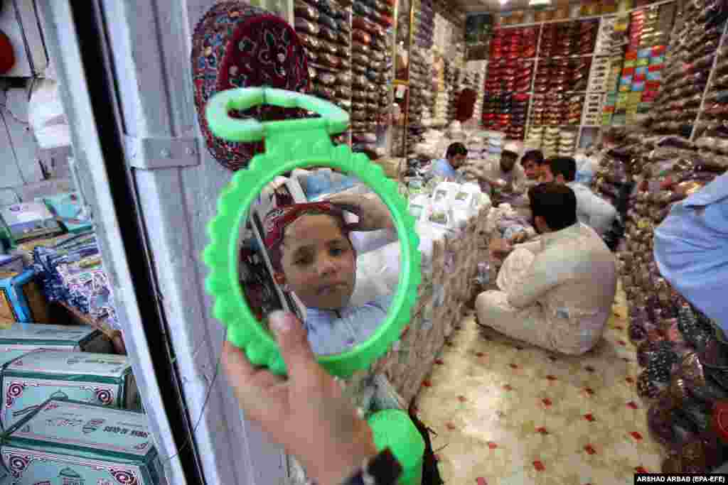A Pakistani tries on a new prayer cap ahead of the holy month of Ramadan in Peshawar on March 29.