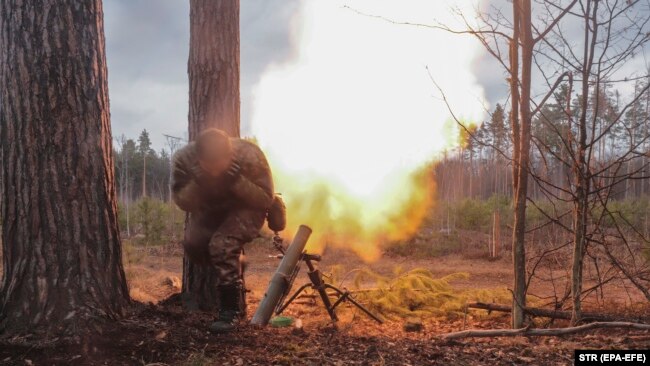 A Ukrainian soldier fires a mortar not far from Kyiv on March 30.