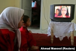 Afghan children watch the Indian family series called Saas Bhi Kabhi Bahu Thi at a guest house in Kabul in 2006.