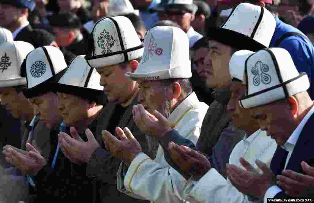 Kyrgyz President Sadyr Japarov (3rd right) prays among worshippers in the center of Bishkek on May 2.