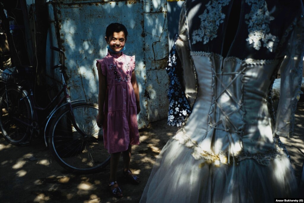 A girl pauses for a photo in the bazaar in Khiva.