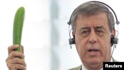 Spanish MEP Francisco Sosa-Wagner holds a cucumber during a debate in the European Parliament on the recent outbreak of E.coli poisoning in Germany.