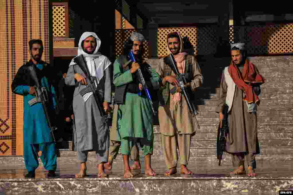Taliban fighters stand guard outside a mosque during Eid al-Fitr prayers in Kabul.&nbsp;