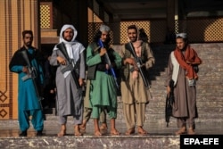 Taliban militants stand guard outside a mosque during Eid al-Fitr prayers in Kabul on May 1.