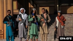 Taliban fighters stand guard outside a mosque during Eid al-Fitr prayers in Kabul on May 1.