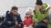 A woman sits with children as evacuees, including civilians who left the area near Azovstal steel plant in Mariupol, arrive at a temporary accommodation center in the Donetsk region in May.