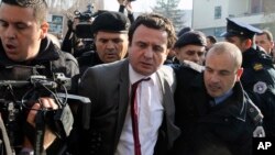 Top opposition lawmaker Albin Kurti (center) being arrested by Kosovar police in November