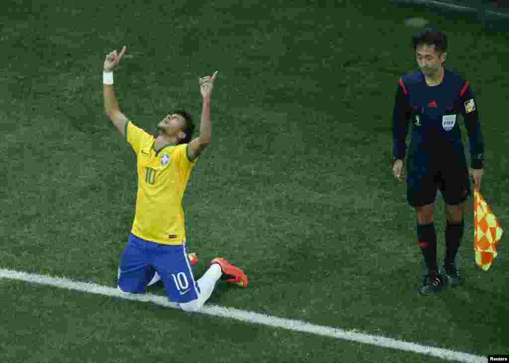 Brazil -- Brazil's Neymar (L) celebrates after scoring a goal from a penalty kick during the 2014 World Cup opening match against Croatia at the Corinthians arena in Sao Paulo June 12, 2014