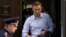 Russian opposition leader Aleksei Navalny leaves after a court hearing in Moscow last month.