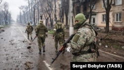 Russian servicemen patrol the captured Levoberezhny District of Mariupol, Ukraine on April 13, 2022.