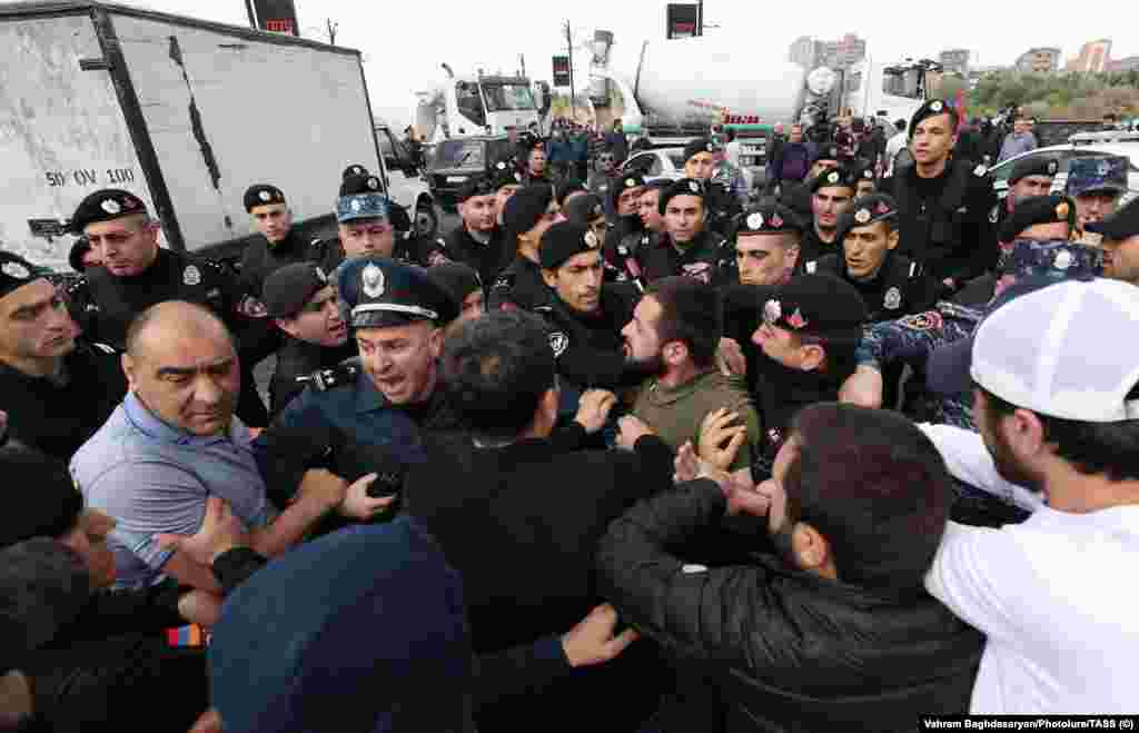 A scuffle breaks out near the trucks on Yerevan&#39;s Kievyan Bridge on May 4. Roadblocks were a key part of the protests that brought Prime Minister Nikol Pashinian to power in the spring of 2018.&nbsp;