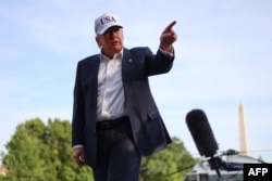 US President Donald Trump gestures as he speaks to reporters after arriving on the South Lawn of the White House in Washington, DC, on May 15, 2026.