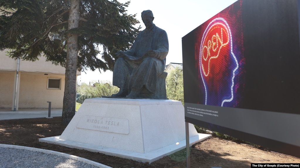 Spomenik Nikoli Tesli u centru Gospića. Slavni znanstvenik je rođen u selu Smiljan kod ovog grada 1856. godine, a prethodni na istom mjestu postavljeni spomenik uništen je druge godine rata u Hrvatskoj 1992. Identičan spomenik je i kod Elektrotehničkog fakulteta u Beogradu. 
