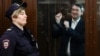 Grigory Melkonyants speaking to supporters from his courtroom cage after his 5-year prison sentence was announced. 