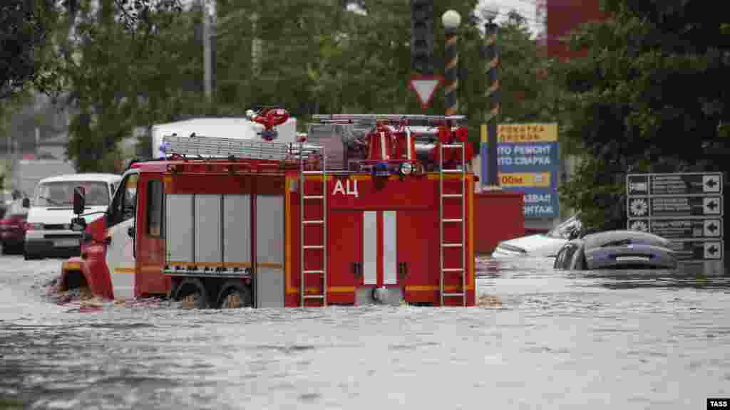 A fire truck makes its way through the floodwaters.