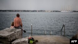 A ship passes along the Croatian coast through Piran on June 27. A court at The Hague has ruled that Zagreb should grant neighboring Slovenia "uninterrupted access" to the high seas via the bay