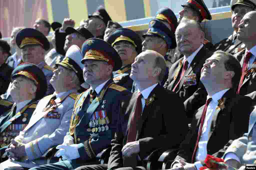 ვლადიმირ პუტინი, დმიტრი მედვედევი და რუსეთის თავდაცვის მინისტრი სერგეი შოიგუ ესწრებიან 9 მაისის აღლუმს. 2014 წელი.